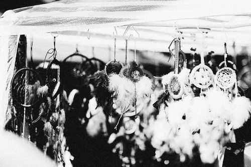 Free A collection of handcrafted dreamcatchers with feathers hanging in black and white style. Stock Photo