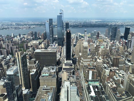 An aerial view showcasing the dense skyscraper landscape of New York City on a clear day.