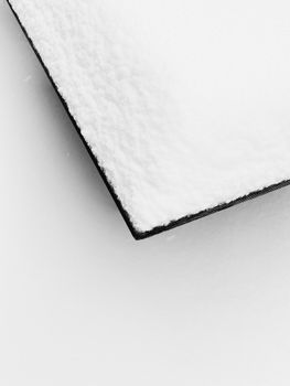 Artistic minimalist photo of a snow-covered surface, capturing the essence of winter.