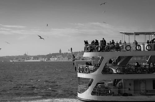 Grayscale Photo of People Riding on Ship