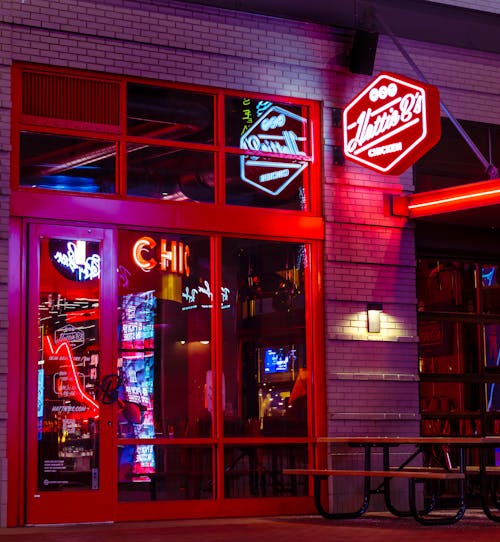 Free Lighted Neon Signages in Front of a Brick Building Stock Photo