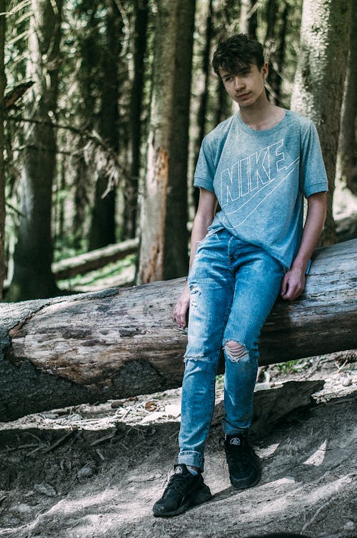 Free stock photo of blue jeans, boots, fallen tree