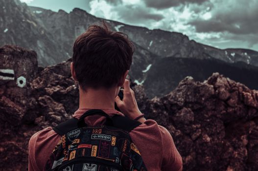 Adventurer takes in breathtaking views at Vysoké Tatry, Slovakia. Perfect for hiking enthusiasts.