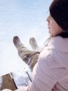 Woman in Winter Clothes Sitting on a Bench