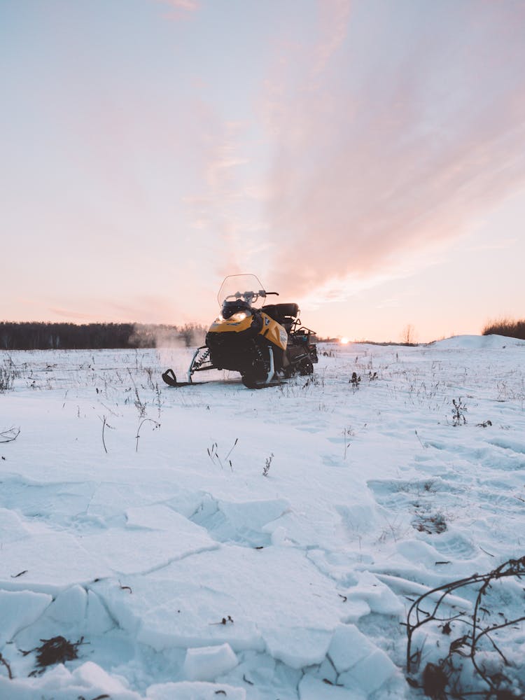 Snowmobile At Sunset