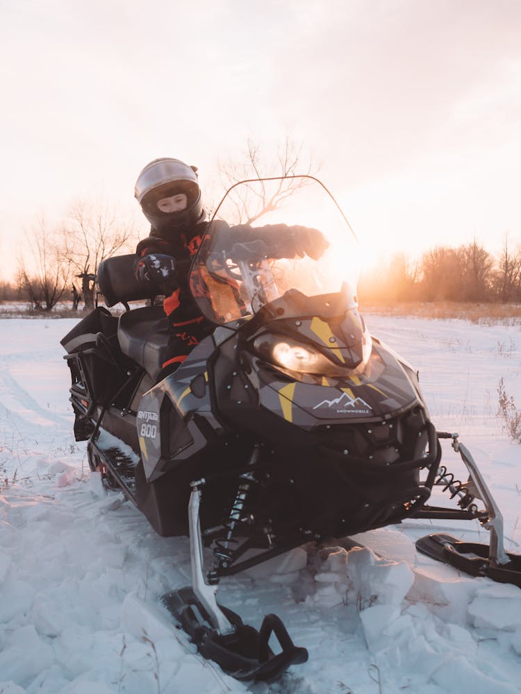 Person On Snowmobile In Winter Field