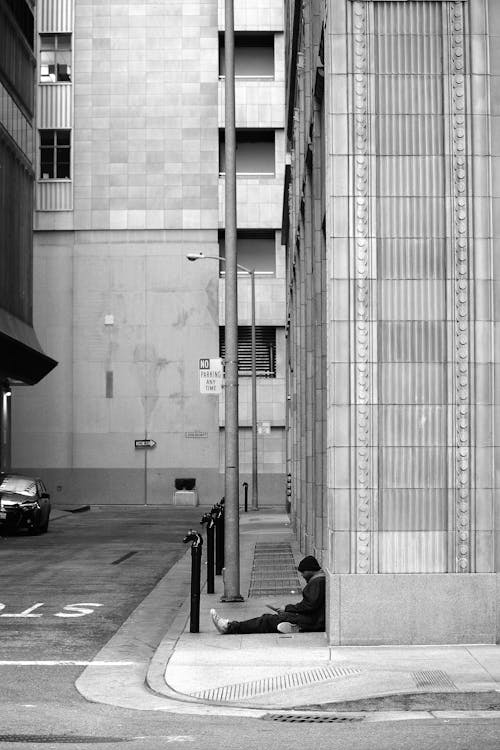 Grayscale Photography of Man on Pavement