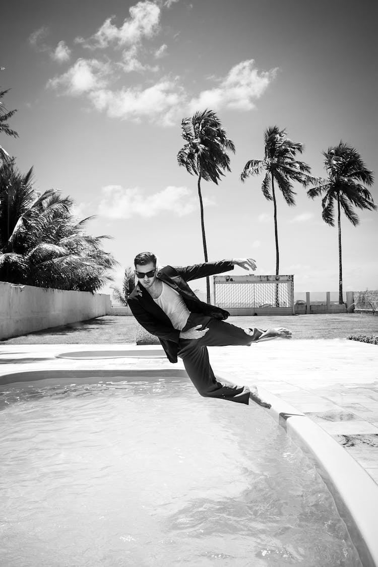 Man Jumping Into Pool With Clothes On 