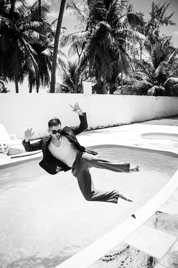 Man In Suit Jumping Into Pool