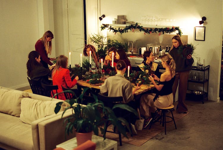 Women Sitting At Table And Making Wreaths