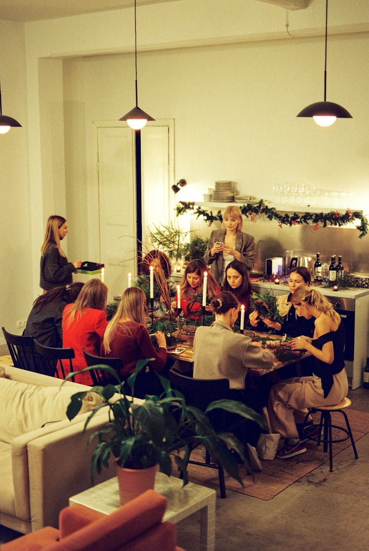 Women Sitting At Table And Making Wreaths