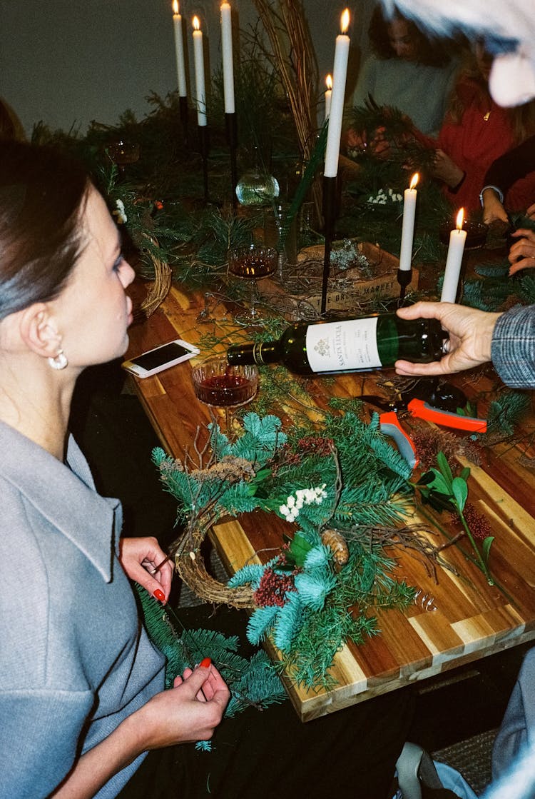 Working On Christmas Wreath With Red Wine