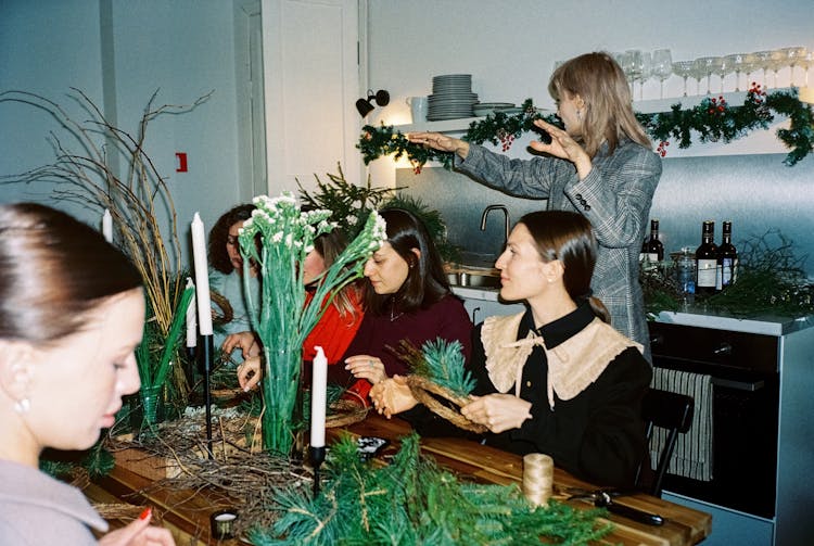 Women Preparing Christmas Wreaths At A Workshop