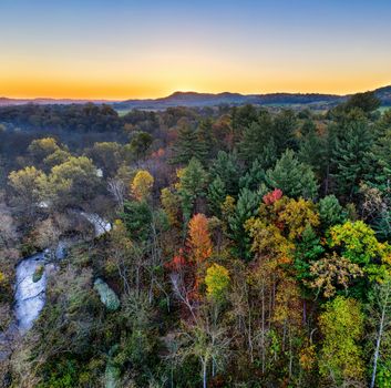 Aerial shot capturing the vibrant autumn foliage in Misha Mokwa, Wisconsin at sunrise.
