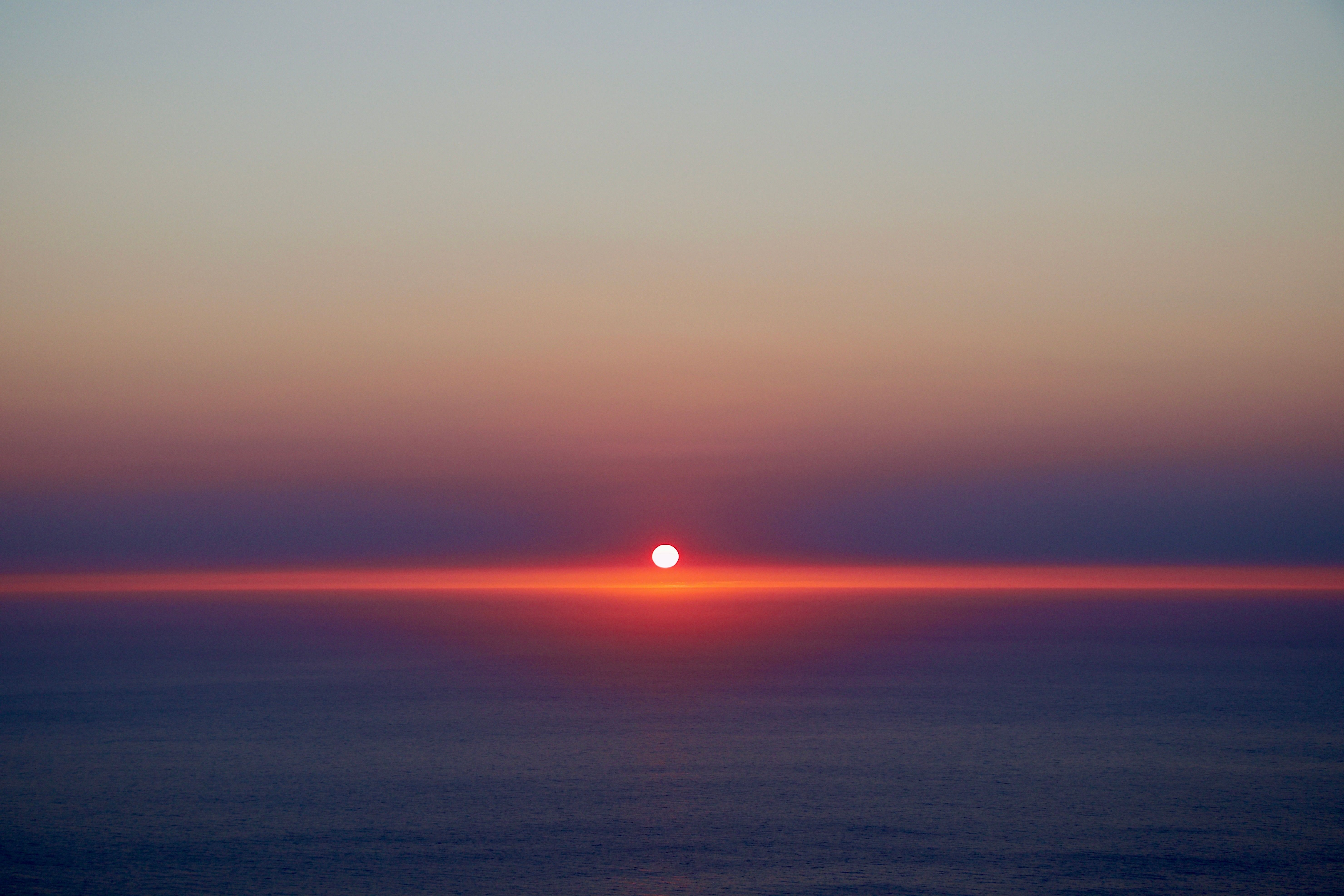 Sunset paints the sky over the tranquil waters of Lefkada, Greece