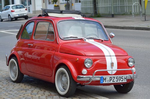 Free Red Fiat Car Parked on the Side of the Street Stock Photo
