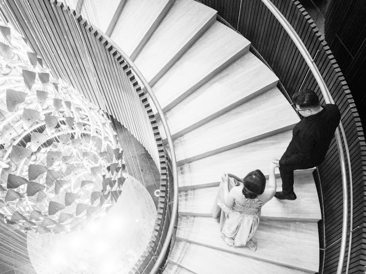 Monochrome Photo Of A Couple Going Up The Stairs