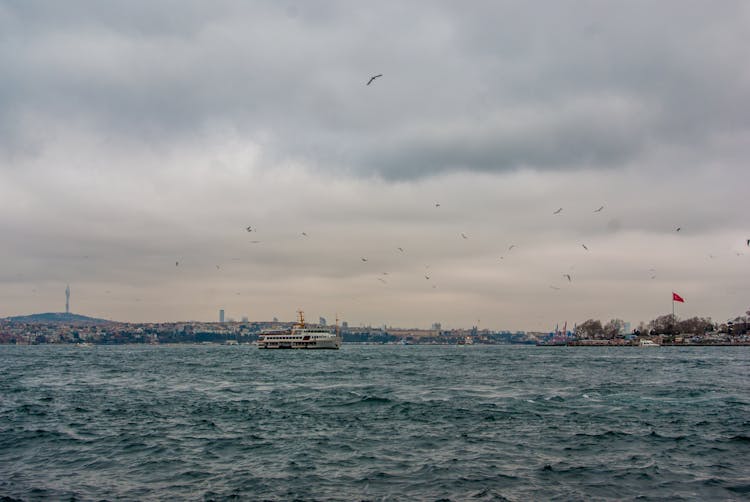 A Ship Cruising On Sea Under Cloudy Sky