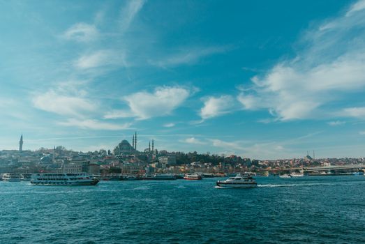 Scenic view of the Bosphorus Strait with ferries and the cityscape of Istanbul, Turkey.