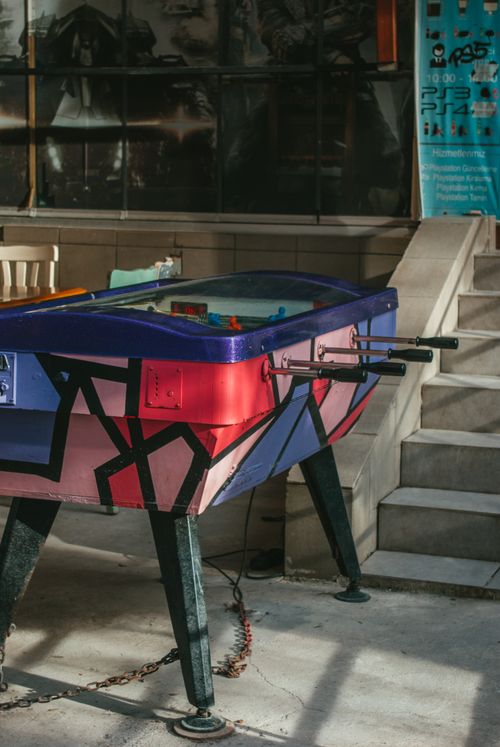 Free Vibrant foosball table with geometric design in a contemporary indoor setting. Stock Photo