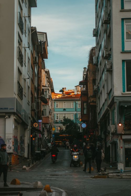 Free A lively urban street scene with pedestrians and traffic in a dynamic city setting. Stock Photo