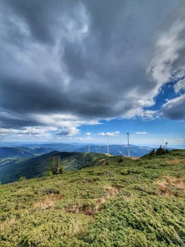 Scenic view of wind turbines under dramatic clouds in Romania's Gârda de Sus.