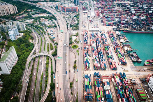 Aerial shot of Hong Kong's vibrant container port and expressway network, highlighting urban infrastructure.
