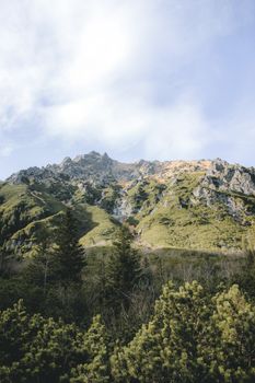 Breathtaking mountain scenery with lush greenery and clear blue skies.