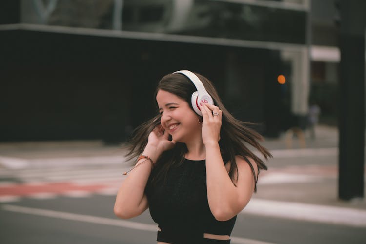 Woman Listening To Music On Street