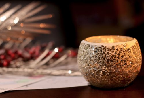 Free Warm and cozy atmosphere with a shimmering candle holder and holiday decorations. Stock Photo