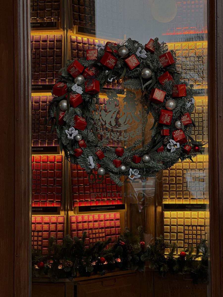 Decorative Christmas wreath displayed on a glass window