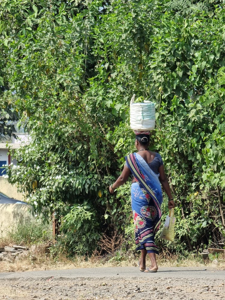 Woman Carrying Bag On Head