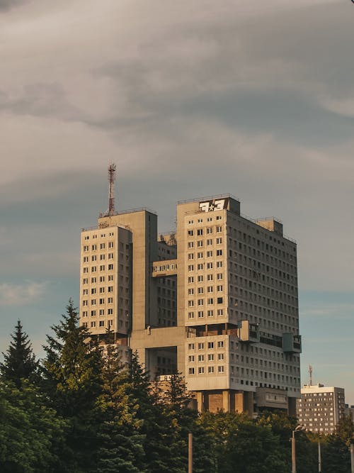 Brown Concrete Building Under Gloomy Sky