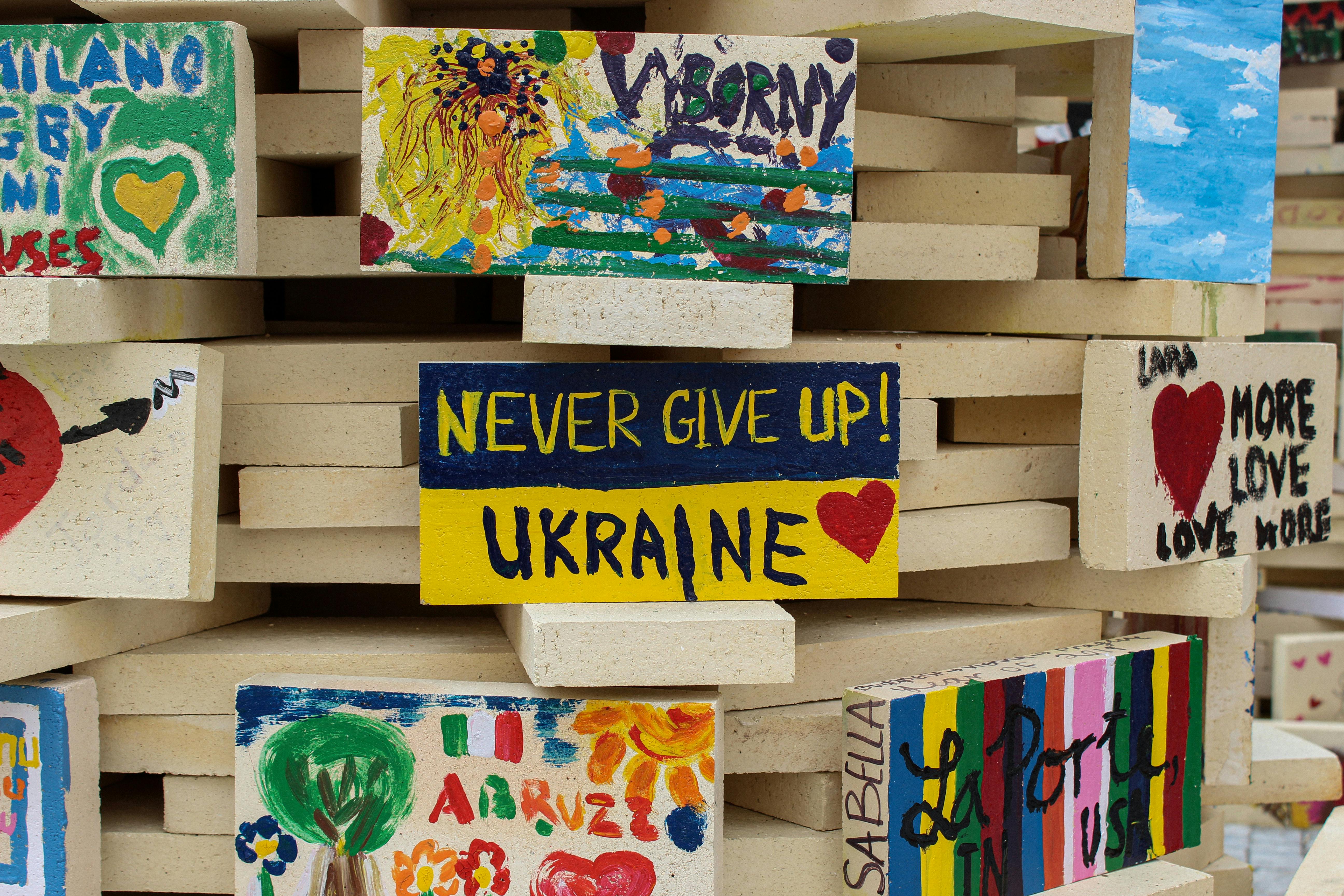 Vibrant painted bricks with supportive messages for Ukraine showcasing unity and hope.