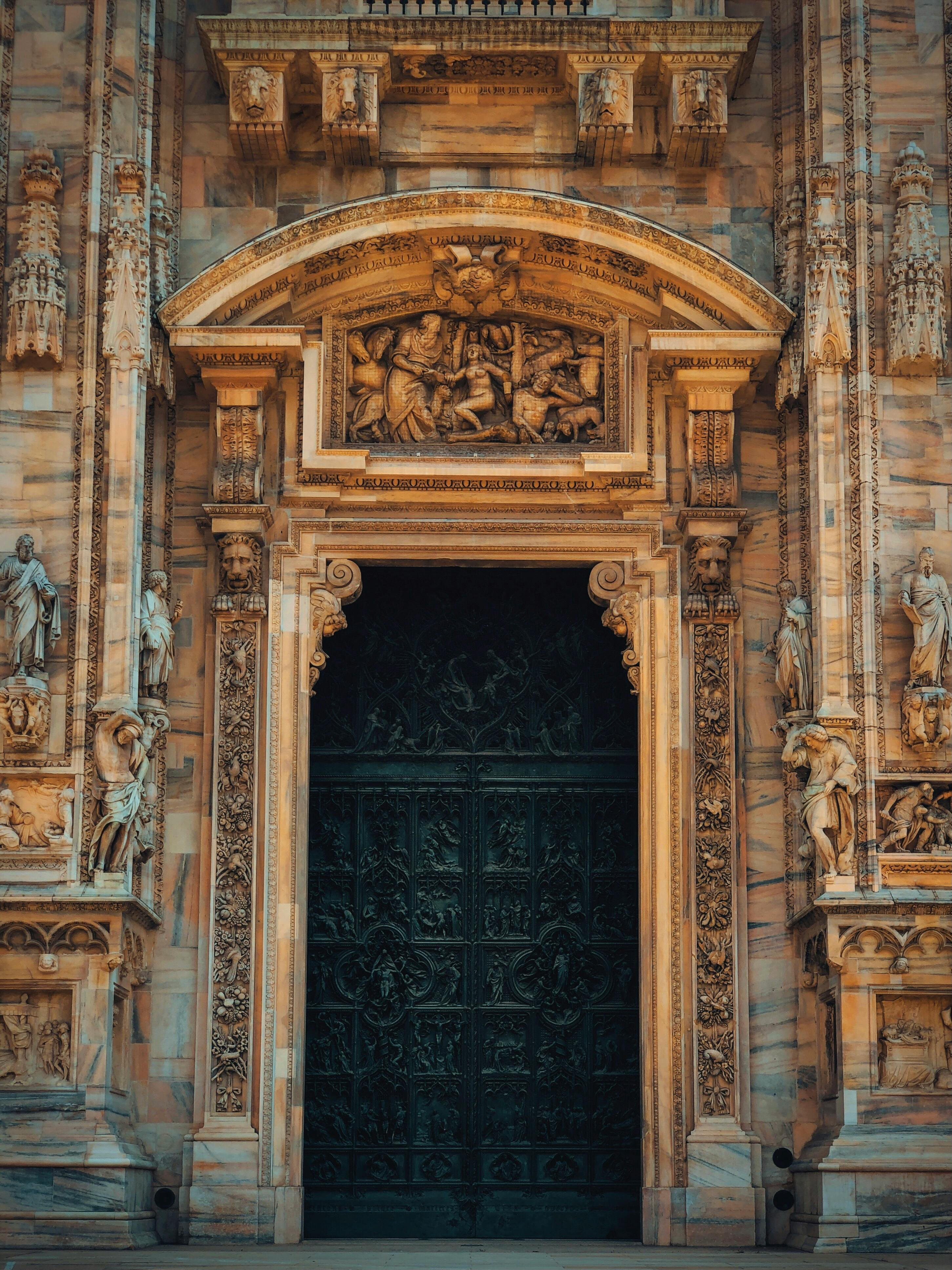 brown concrete building with black metal door