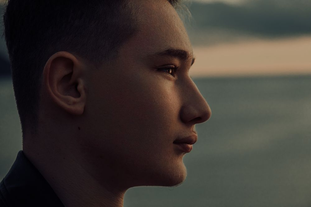 Close-up profile portrait in warm evening light — photo by Atahan Demir on Pexels