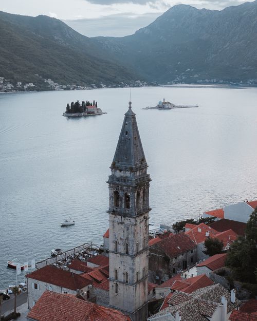 Free Aerial shot of the iconic bell tower and islands in Kotor Bay, Montenegro, near Perast. Stock Photo