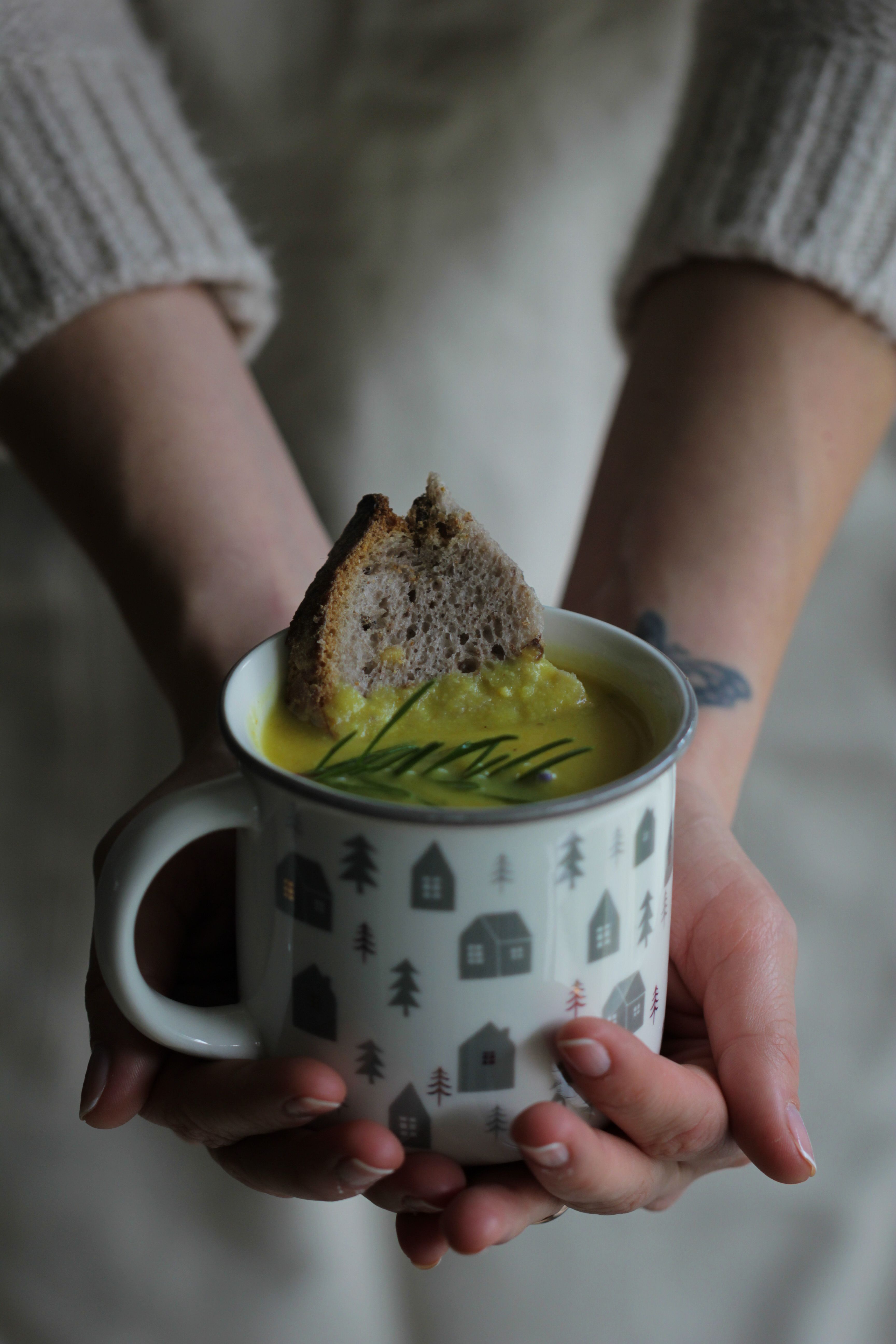 Warm soup served in a Scandinavian style mug, perfect for chilly days.