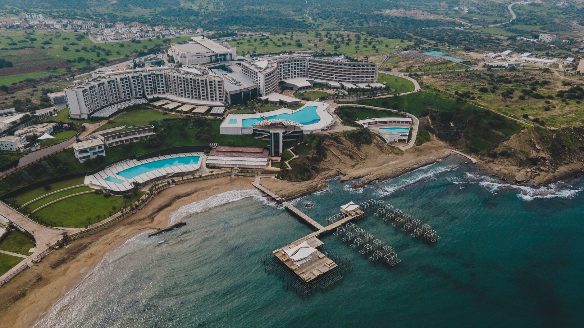 Stunning aerial view of a luxurious resort featuring pools and beachfront access.