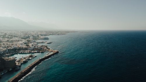 Free Stunning aerial photograph of a city along the coast with a vibrant harbor. Stock Photo