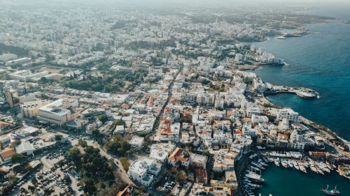 Free Stunning aerial view of a coastal city with a bustling harbor and expansive waterfront. Stock Photo