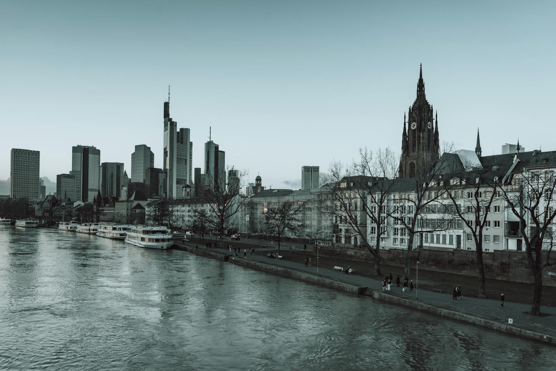 Skyline view of Frankfurt city with Main River and towering skyscrapers.