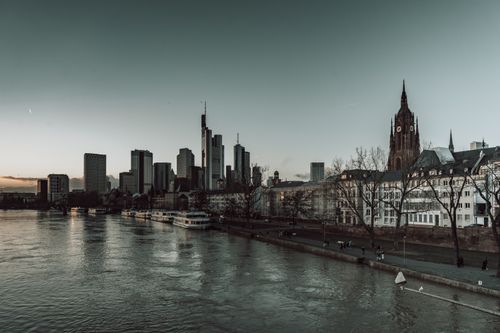 Free Serene dusk view of Frankfurt's skyline along the Main River with historic architecture. Stock Photo
