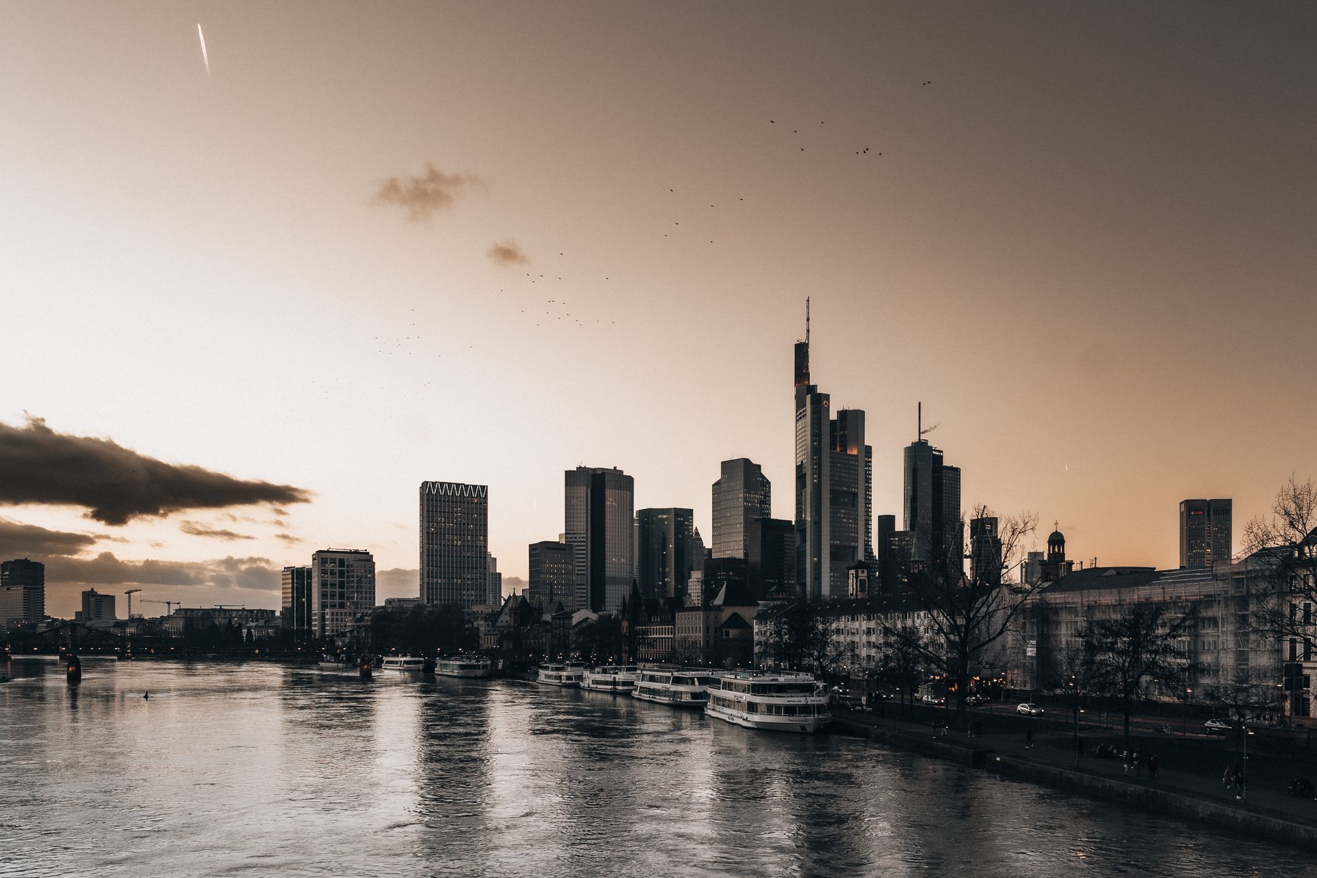 European Central Bank tower and Frankfurt skyline at dusk.