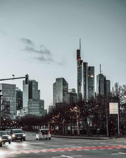 Free A cityscape featuring skyscrapers, traffic, and a cloudy sky, capturing urban life. Stock Photo