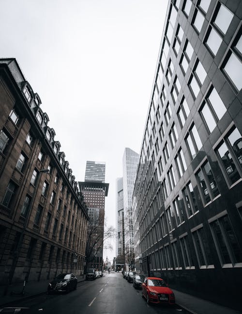 Cars Parked in a Street Between Buildings