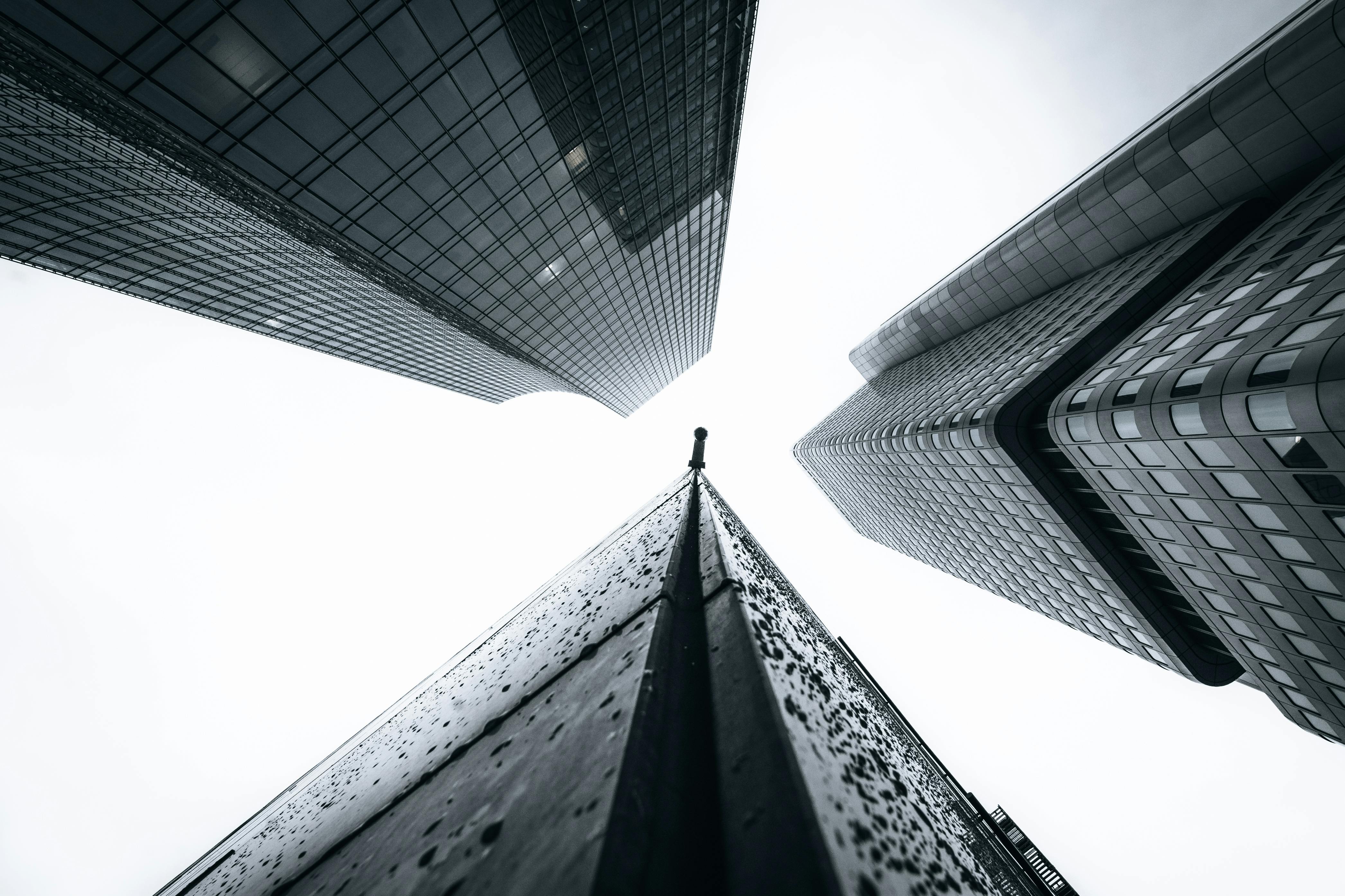 Monochrome Photo of Waiting Shed Near Buildings · Free Stock Photo