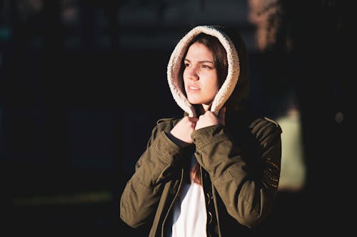 Woman in Green Jacket Looking Afar