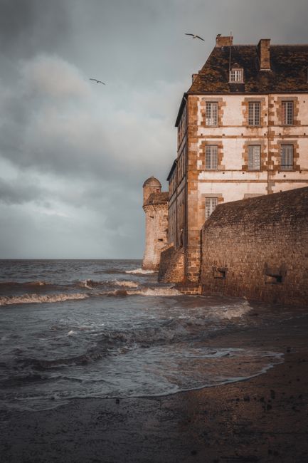 Explore Mont Saint-Michel's stunning seashore and historic stone architecture in Normandy, France.