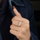 Person Wearing Silver Ring Holding Black Textile